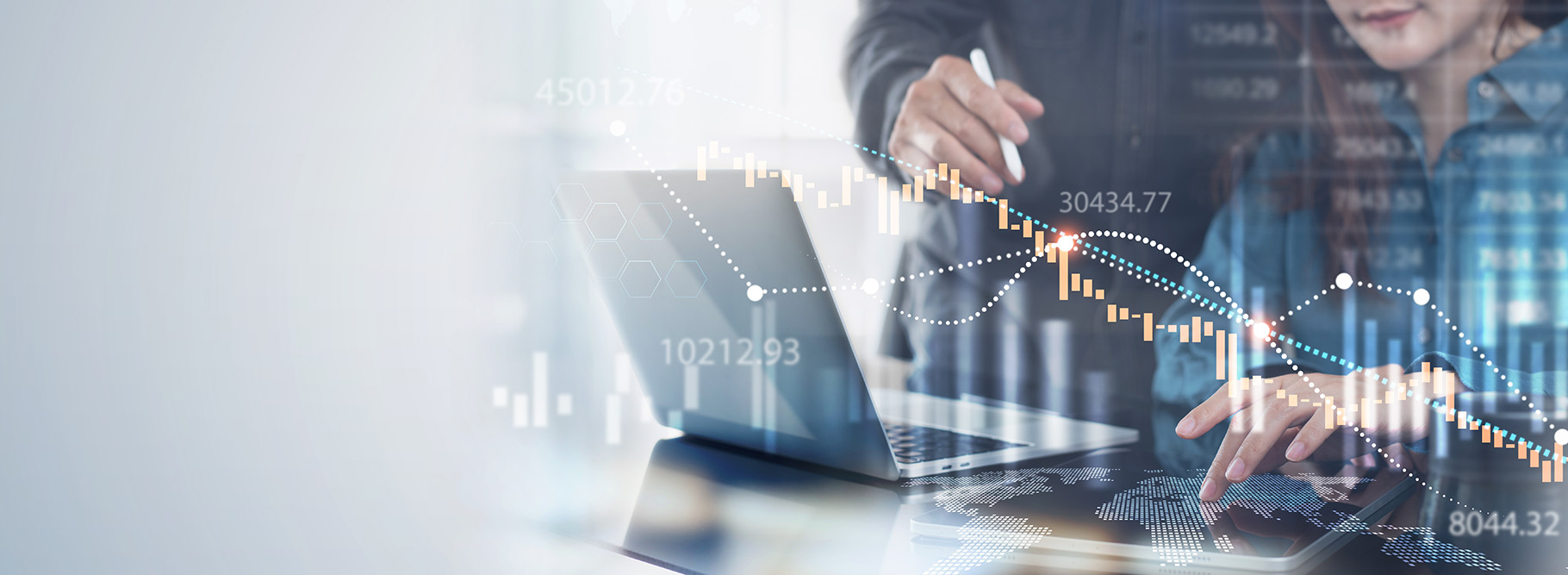 Colleagues in front of a laptop figuring out direct and indirect manufacturing costs