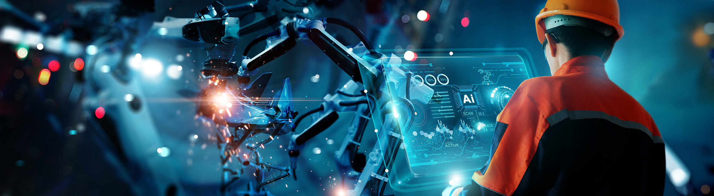 Engineer looking at AI data on a screen for a manufacturing robotic arm